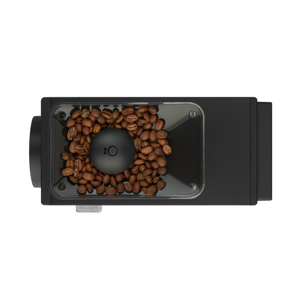 Top view of grinder with coffee beans.