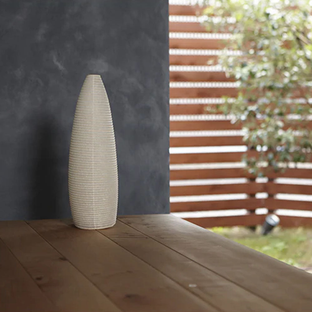 Photo of ASANO&#39;s &#39;Cone Paper Moon&#39; washi paper lamp shade on a wooden outdoor deck.