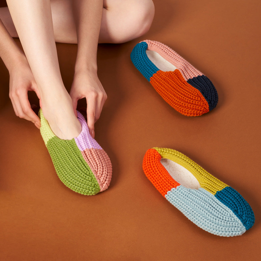 Close-up view model putting on slipper.