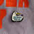 The Joonbug Scenic Drive Pin displayed on its packaging.