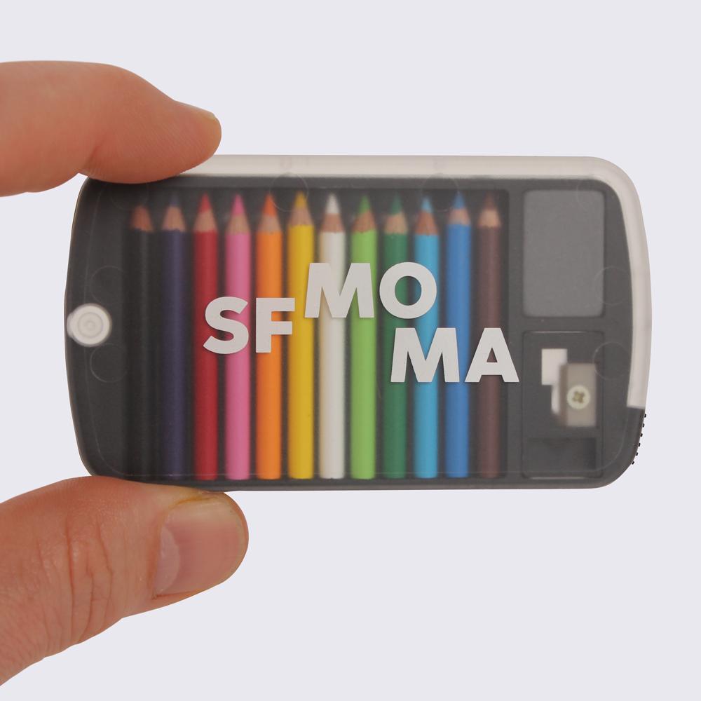 A SFMOMA Mini Pencil Set held between two fingers.