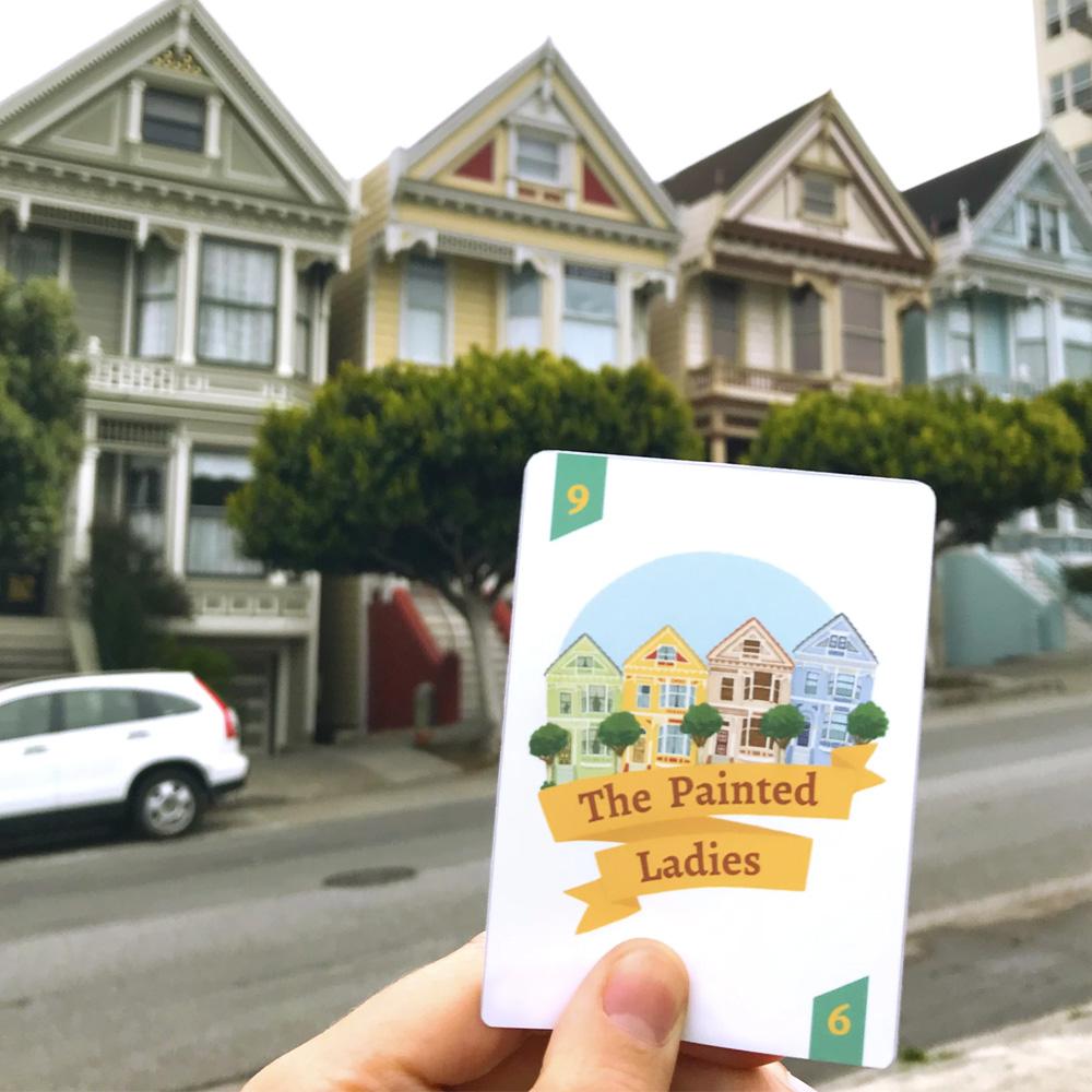 The Painted Ladies card from the San Francisco vs Fog Game held in front of the real houses.