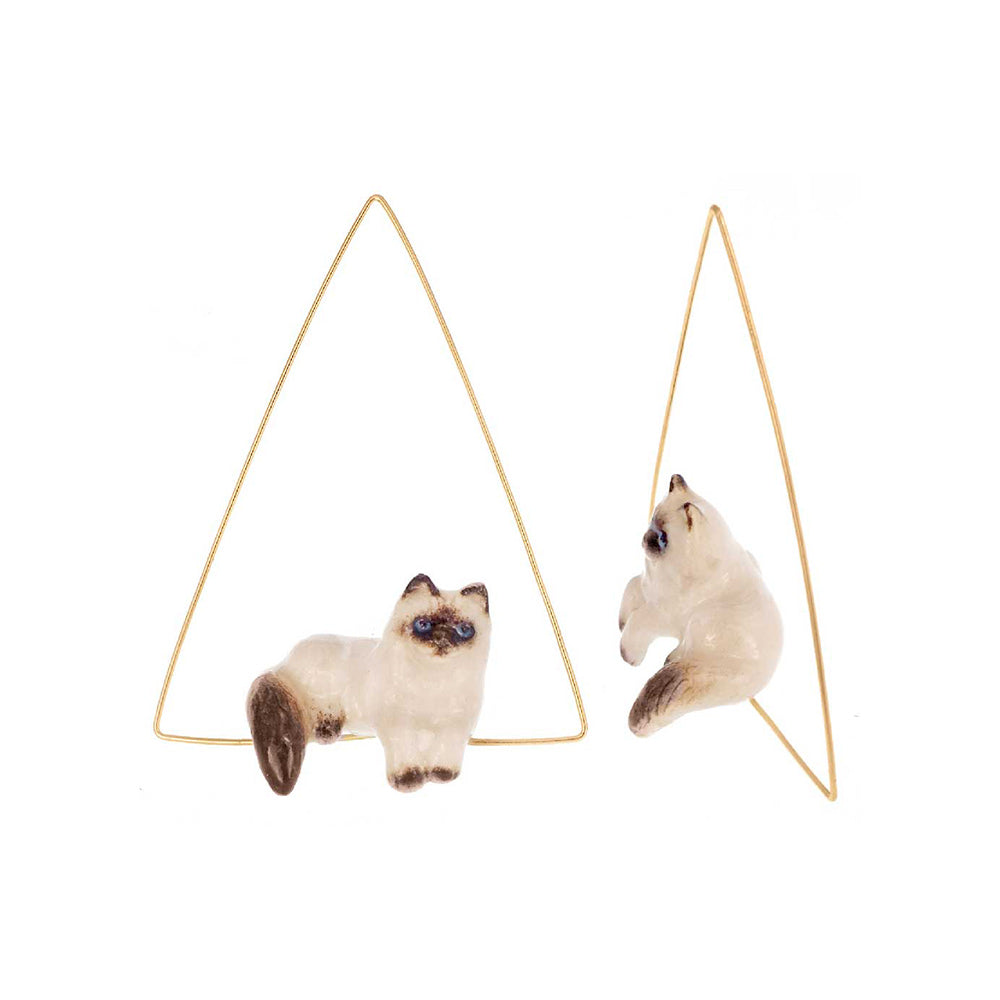 Siamese Cat Triangle Earrings by Nach on white background.