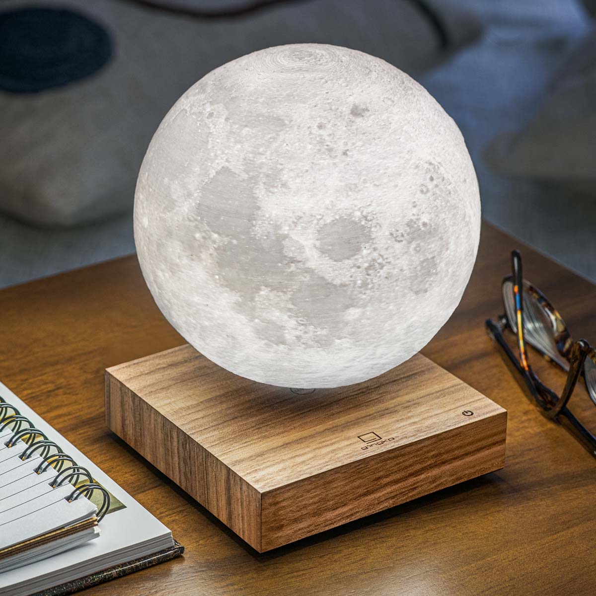 A Smart Moon Lamp: Walnut displayed on a work desk.