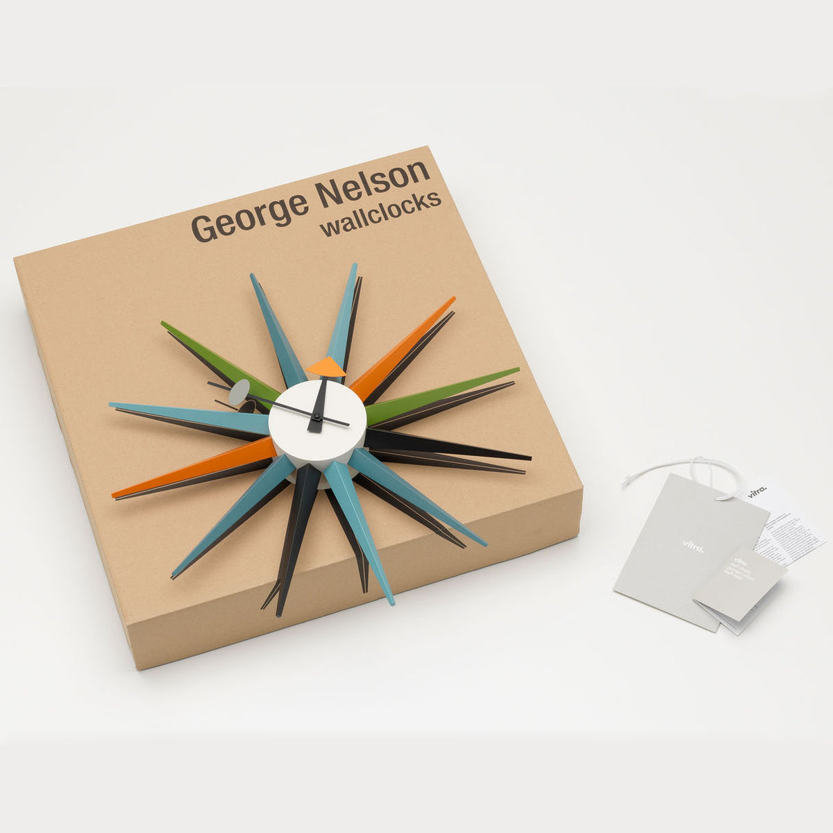The Sunburst Clock: Multicolor displayed with its packaging.