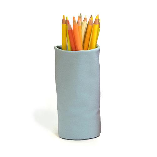A Sacco Glasses Holder: Grey Blue holding colored pencils.