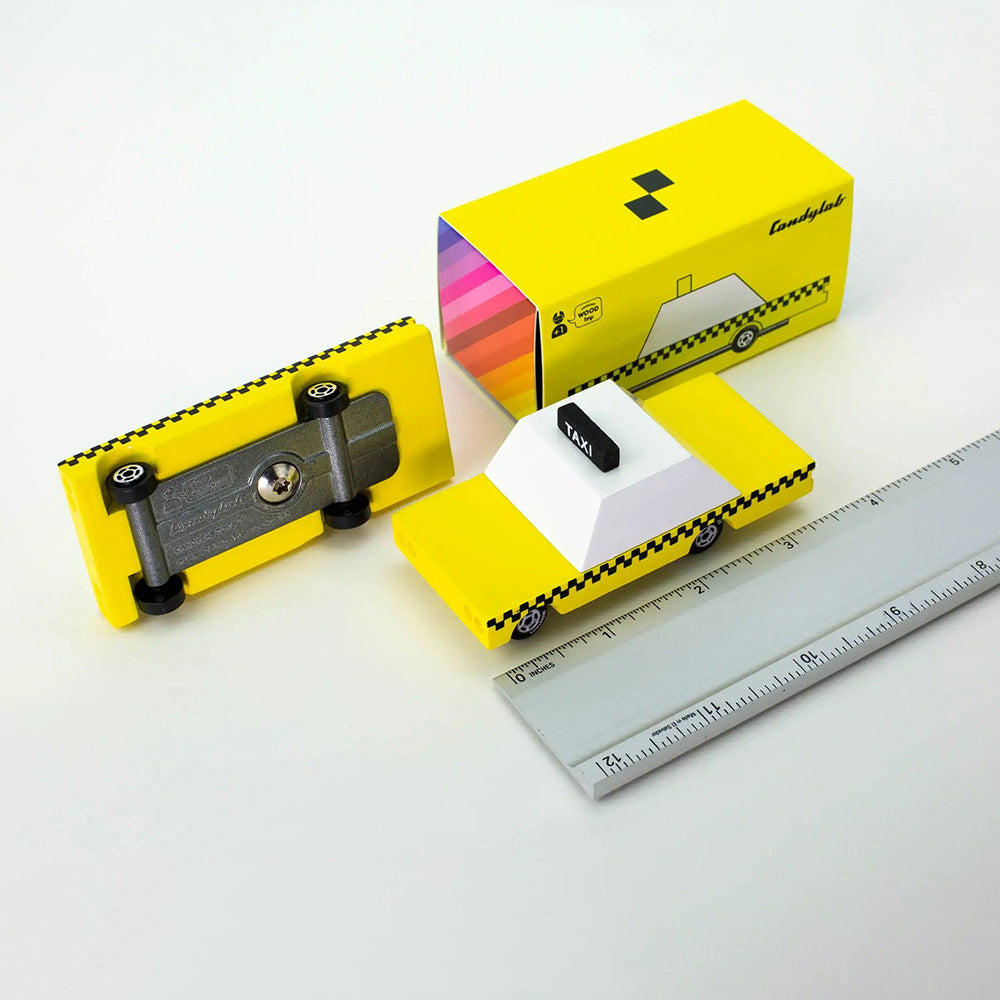 Top view of taxi with ruler and packaging.