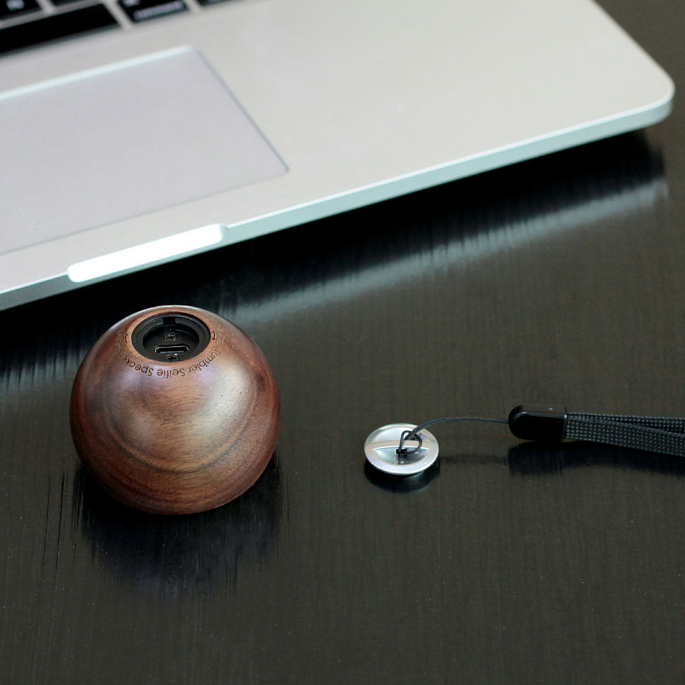 A close up of the Tumbler Selfie Speaker: Walnut&#39;s USB port and cover.