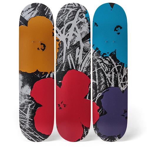 All three decks from the Warhol Flowers Triptych Skateboards: Multi displayed standing side by side.